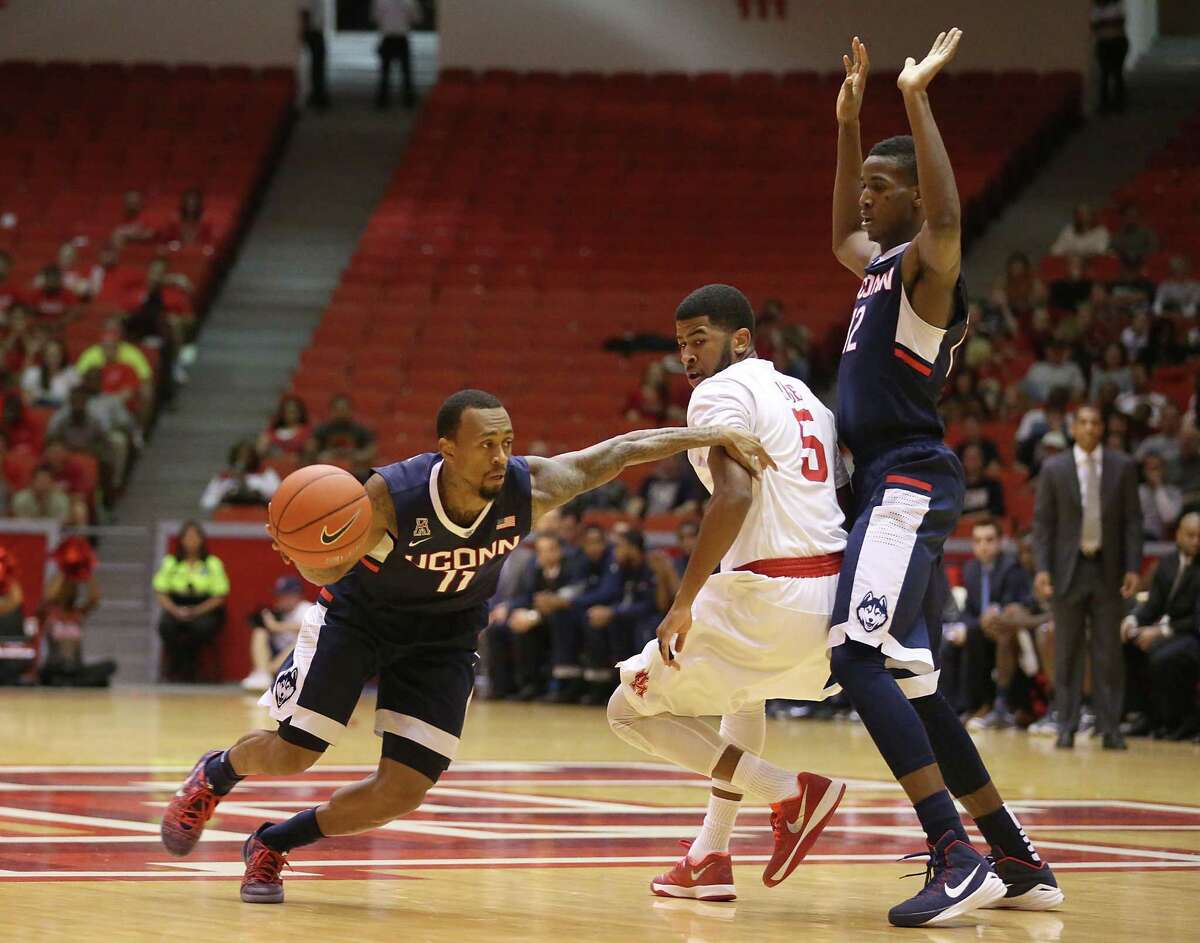 UConn’s Ryan Boatright (11) dribbles around Houston guard L.J. Rose while Kentan Facey sets a pick in the first half Sunday.