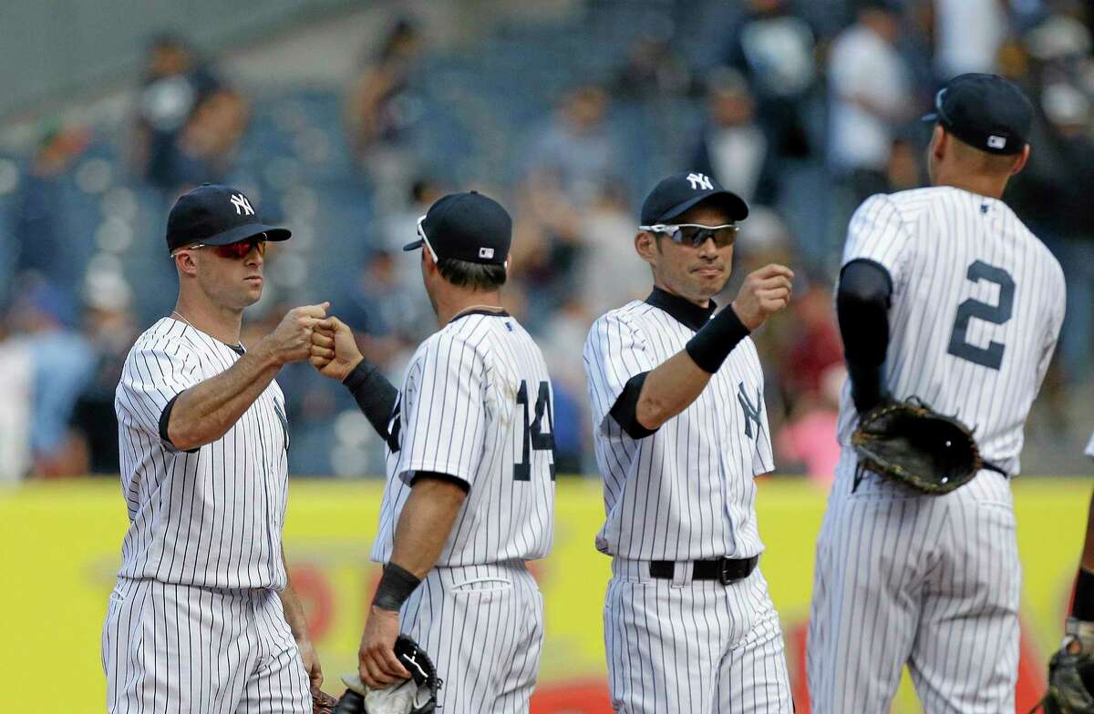 Yankees Brett Gardner, left, and Ichiro Suzuki, second from right, celebrate with teammates after Thursday’s 2-1 win over the Oakland Athletics in New York.