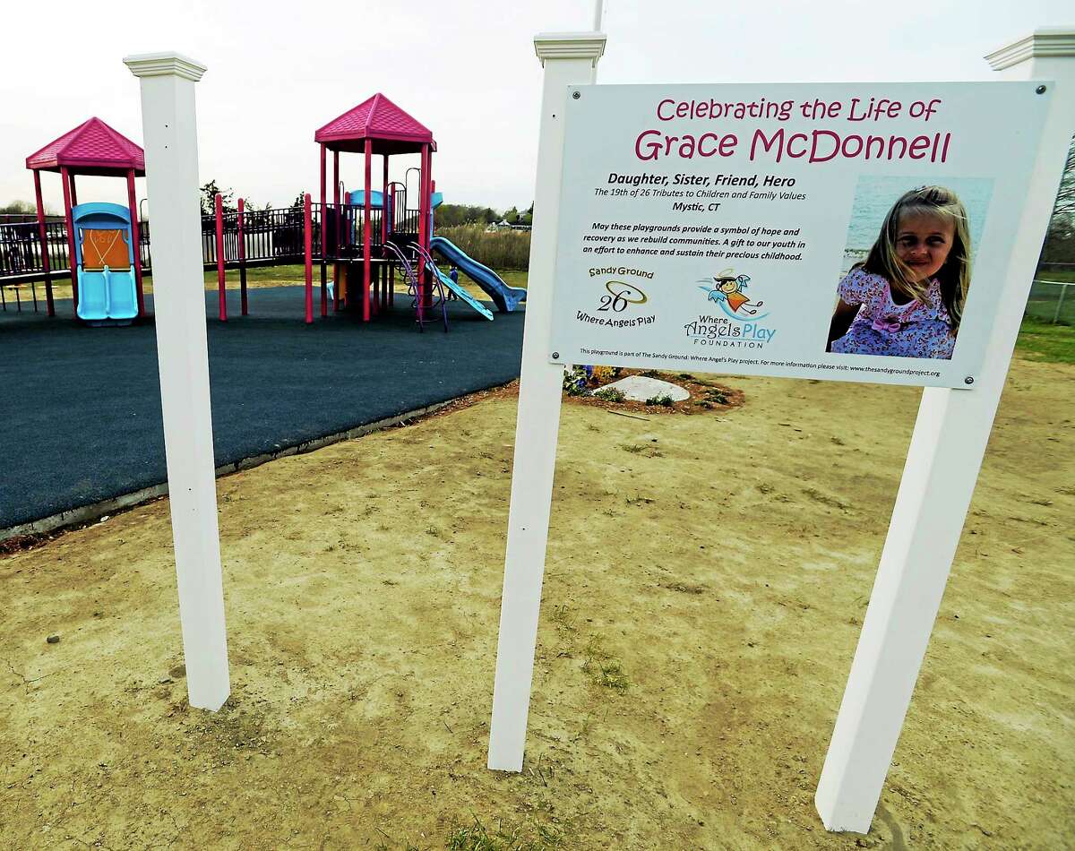 This May 7, 2014 photo shows a gap shows where one of the brand new signs, depicting a peace sign, for the Grace McDonnell playground in Stonington, Conn. was stolen.