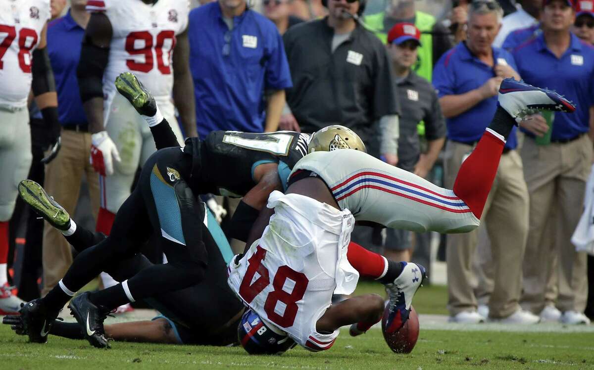 Stephen B. Morton — The Associated Press Giants tight end Larry Donnell (84) fumbles the ball after being hit by Jaguars cornerback Dwayne Gratz during the second half Sunday.