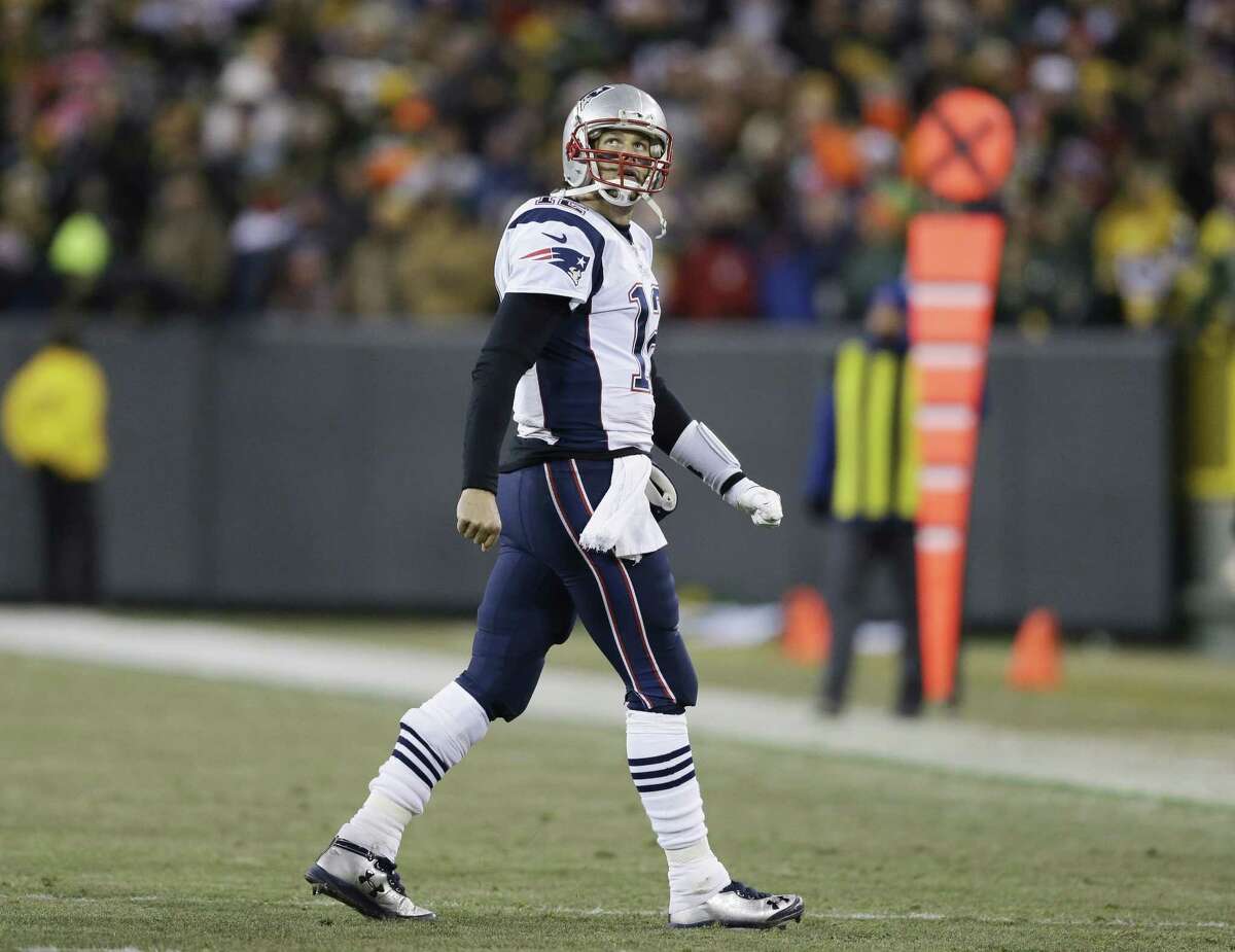 Patriots quarterback Tom Brady looks back as he walks off the field during the second half Sunday in Green Bay.
