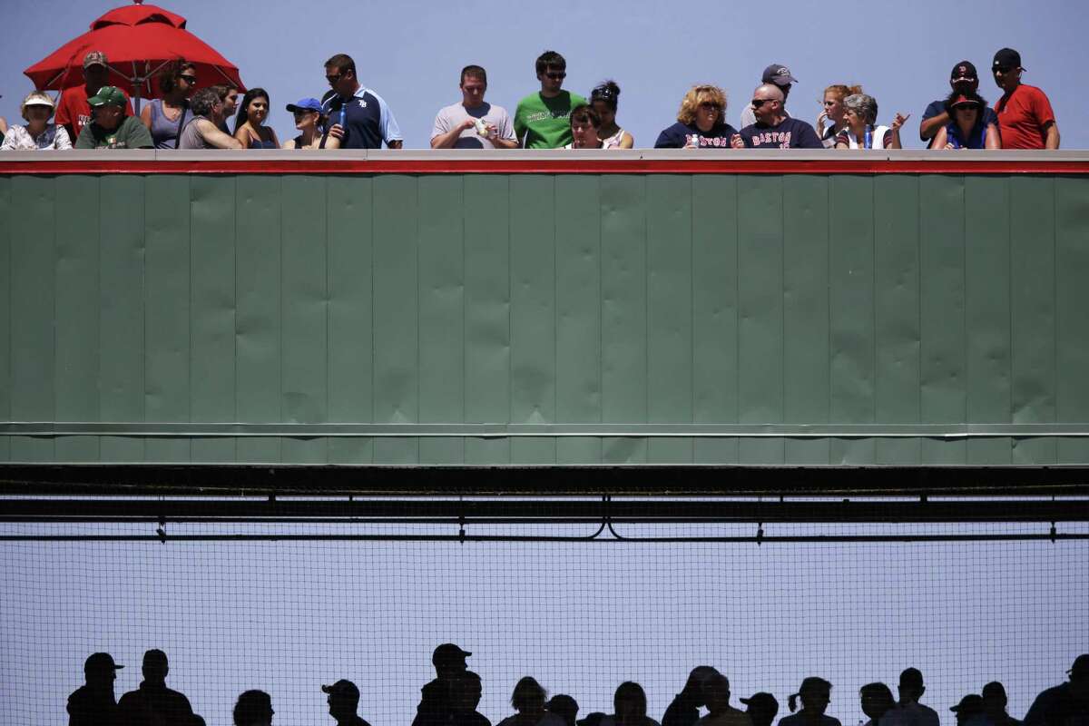 Fans watch a baseball game on the Green Monster replica at JetBlue park between the Tampa Bay Rays and the Boston Red Sox on Sunday in Fort Myers, Fla.