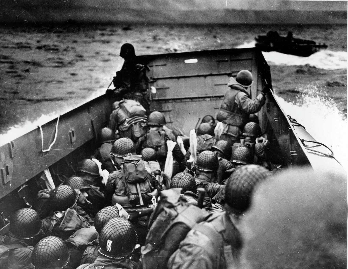 FILE - In this June 6, 1944, file photo, Allied troops crouch behind the bulwarks of a landing craft as it nears Omaha Beach during a landing in Normandy, France. (AP Photo/U.S. Coast Guard, File)