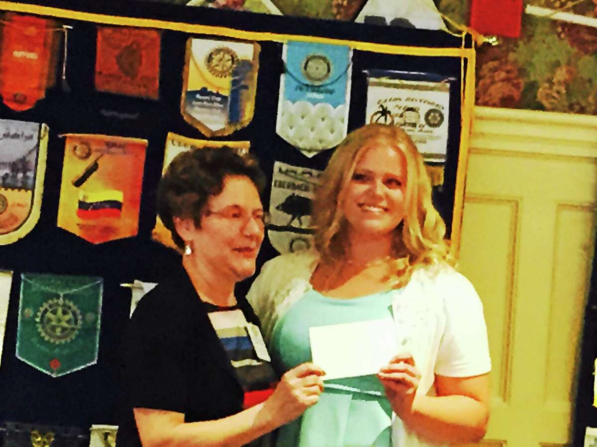 Middletown High School junior Anna Grygorowicz accepts her Service Above Self Award from Lois Muraro of the Middletown Rotary Club. The teen performed over 200 hours of service to the Capuchin Youth and Family Services.