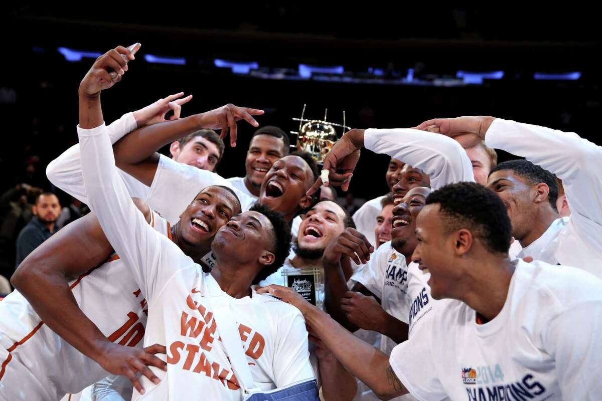 Texas players celebrate with the 2K Classic championship trophy after beating California at Madison Square Garden in New York on Nov. 21. The Longhorns will be in Gampel Pavilion today to take on 24th-ranked UConn.