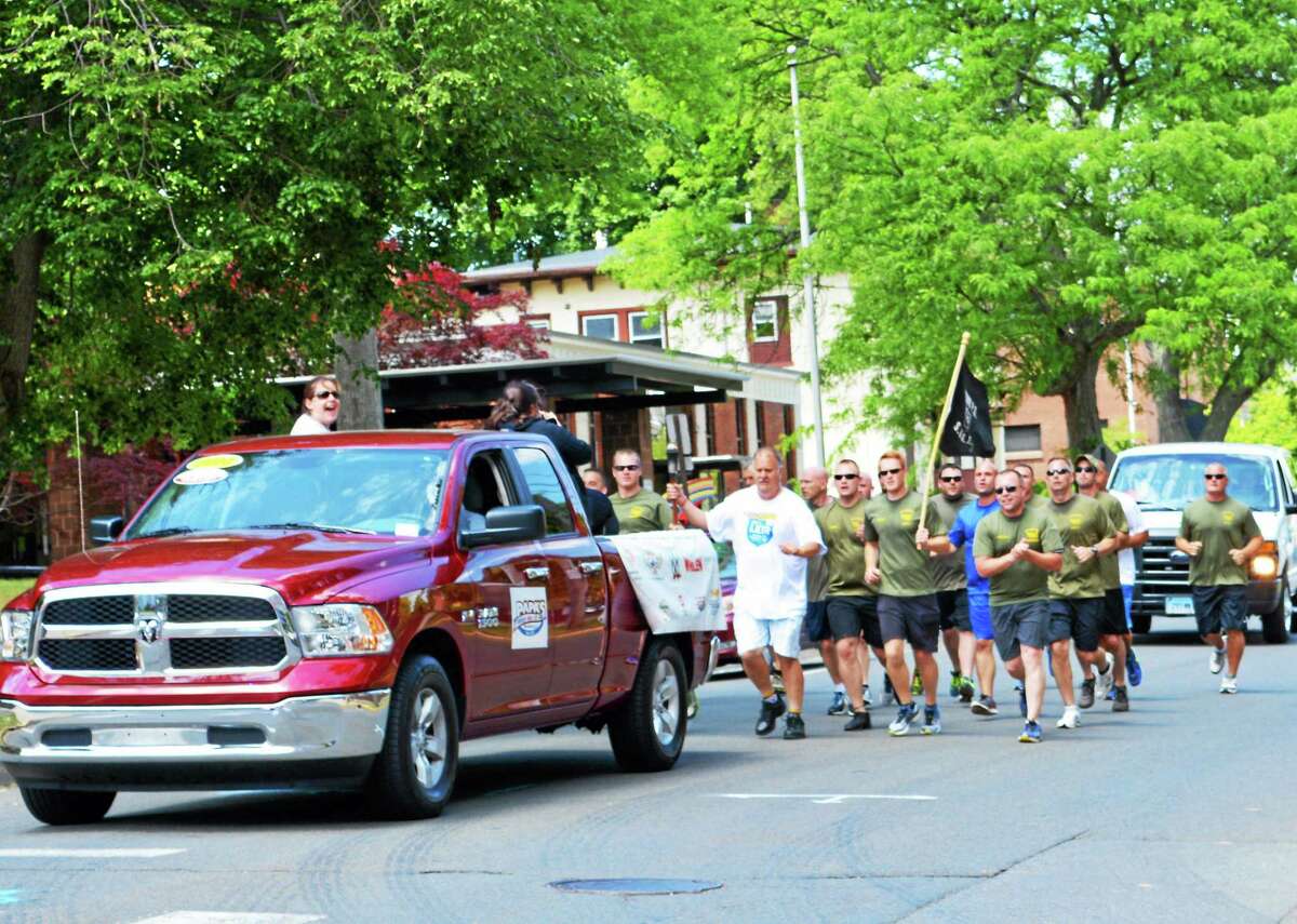 The Special Olympics Connecticut Torch Run swept through Middletown just after noon June 4 on its fourth leg of a three-day trek through the state from North Branford to Hartford. Here, runners make their way down Broad Street just before a break for lunch.