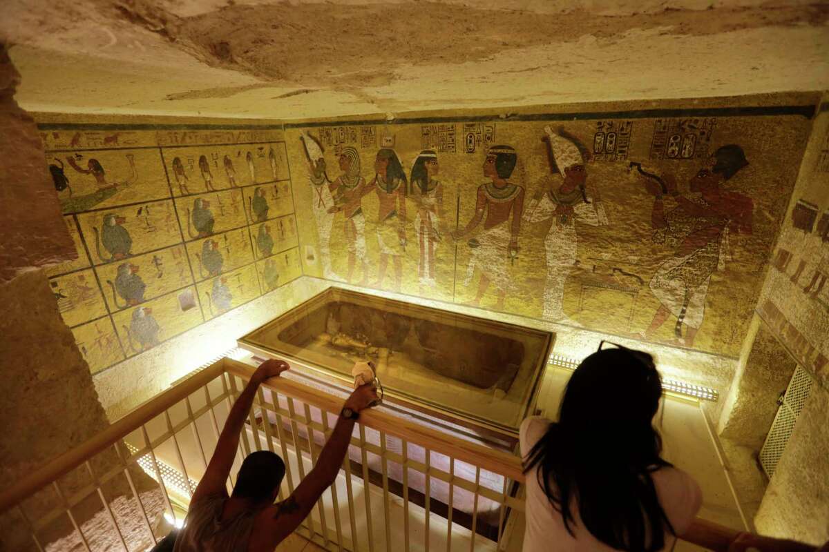 In this Thursday, Nov. 5, 2015, file photo, tourists look at the tomb of King Tut as it is displayed in a glass case at the Valley of the Kings in Luxor, Egypt. On Saturday, Nov. 28, 2015, Egyptian Antiquities Minister Mamdouh el-Damaty said there is a 90 percent chance that hidden chambers will be found within King Tutankhamun’s tomb, based on the preliminary results of a new exploration of the 3,300-year-old mausoleum.