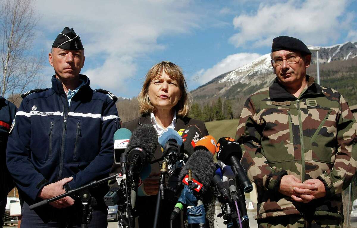 Patricia Willaert, center, the prefect in charge of regional law and safety, speaks during a press conference in Seyne, France, Tuesday, March 31, 2015. European investigators are focusing on the psychological state of a 27-year-old German co-pilot who prosecutors say deliberately flew a Germanwings plane carrying 150 people into a mountain, a French police official said Monday. (AP Photo/Claude Paris)