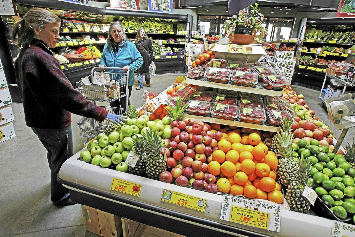 This April 16, 2013, file photo shows customers shopping for produce at the Hunger Mountain Co-op in Montpelier, Vt. Vermont’s 17 food cooperatives are supporting a bill that would require the labeling of genetically modified foods.
