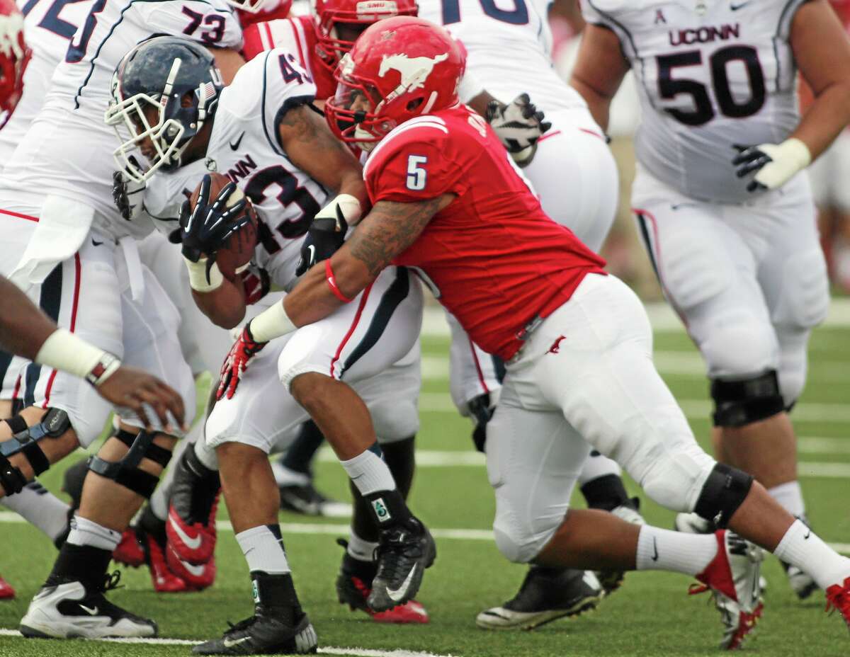 SMU’s Randall Joyner (5) tackles UConn’s Lyle McCombs (43) in the first half of a Nov. 16, 2013 game in Dallas.
