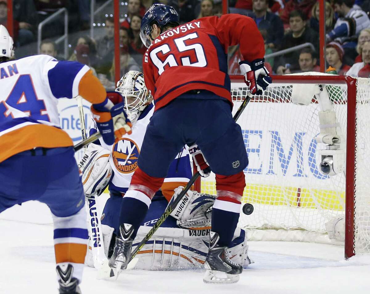 New York Islanders goalie Chad Johnson can’t stop a goal by Washington defenseman Matt Niskanen (not shown) with Capitals left wing Andre Burakovsky (65) nearby during the Capitals’ 5-2 win on Friday in Washington.