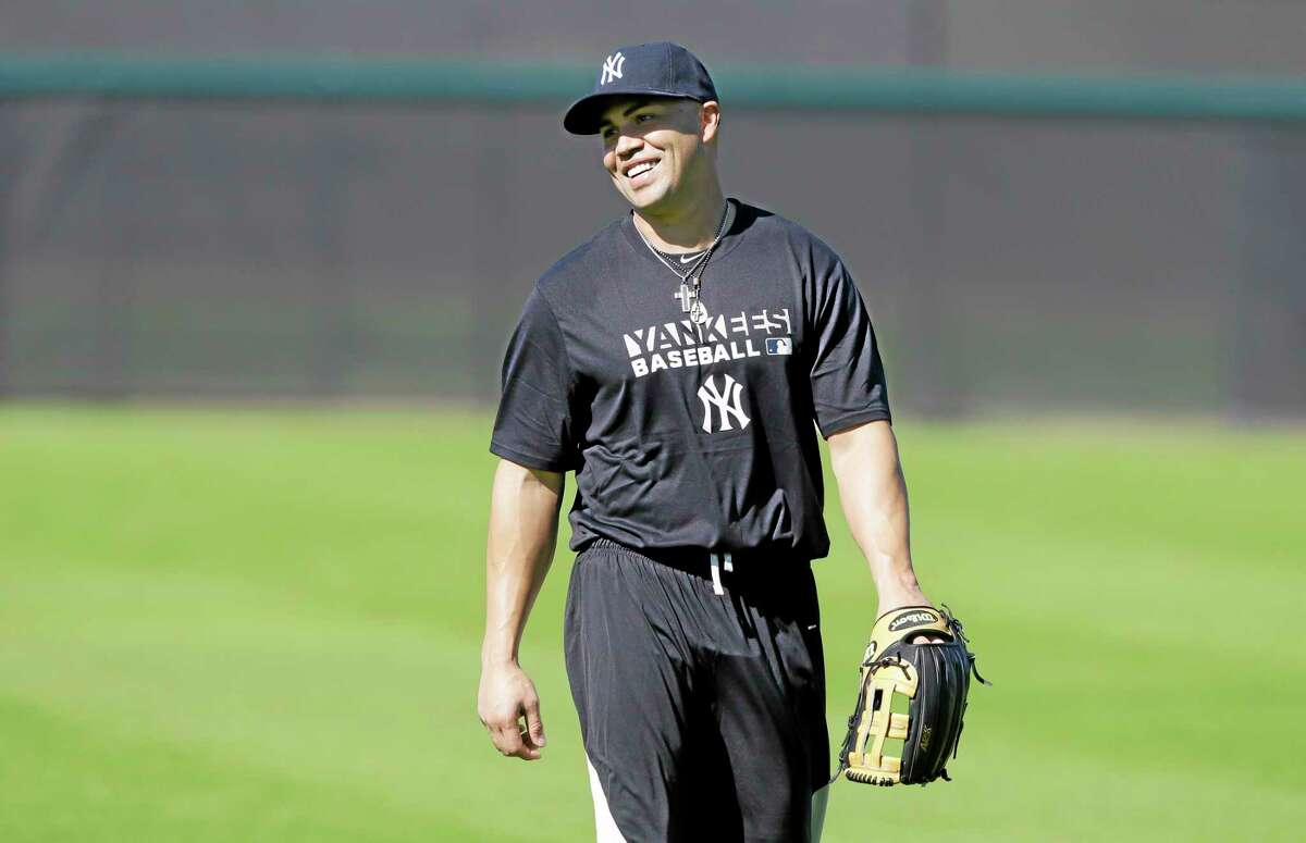 Yankees outfielder Carlos Beltran walks in the outfield during practice Monday in Tampa, Fla.