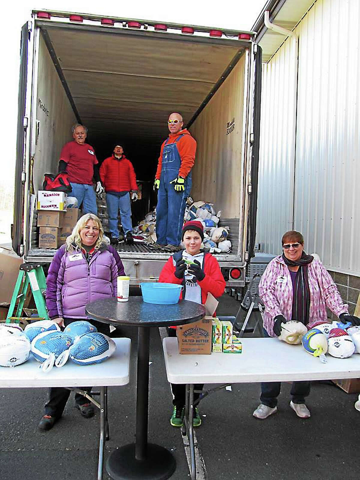 Volunteers from the Middletown Community Thanksgiving Project distributed turkeys this week. Pictured, front row, from left are Gabriele Nyenhuis, Marcus Santamaria, and Helen Roy; in the truck, from left, are Rodney Roy, Steve Koller and Roy J. Cooper.
