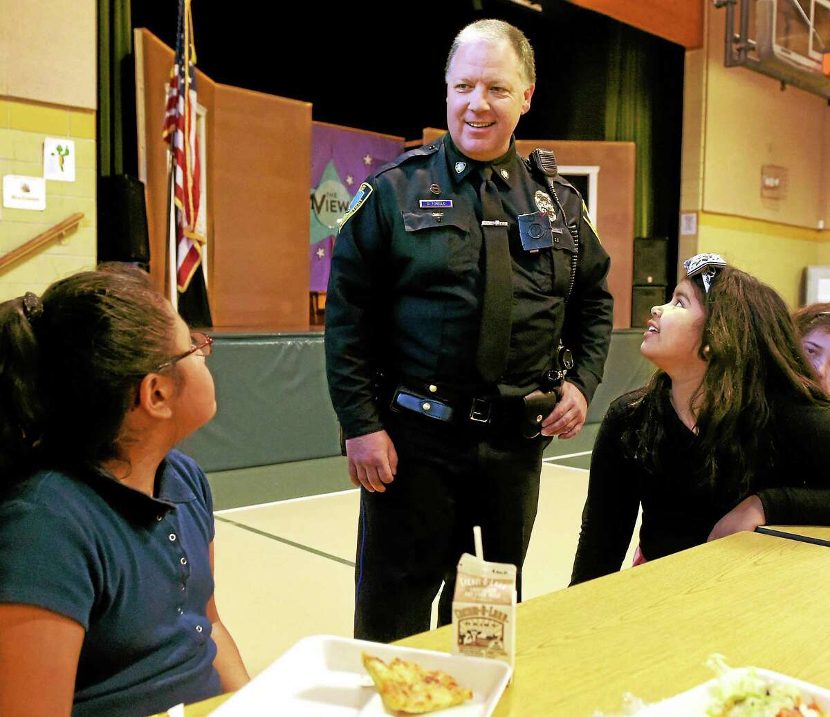 East Haven Police Officer Dave Torello, D.A.R.E. program officer, with Tuttle School fourth-graders during lunch in East Haven Friday.