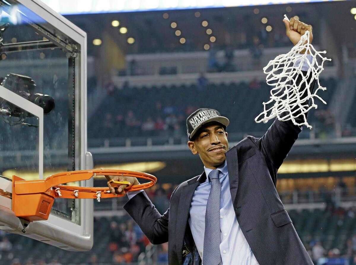 UConn men’s basketball coach Kevin Ollie cuts down the net after the Huskies’ 60-54 victory over Kentucky in national championship game on April 7 in Arlington, Texas.
