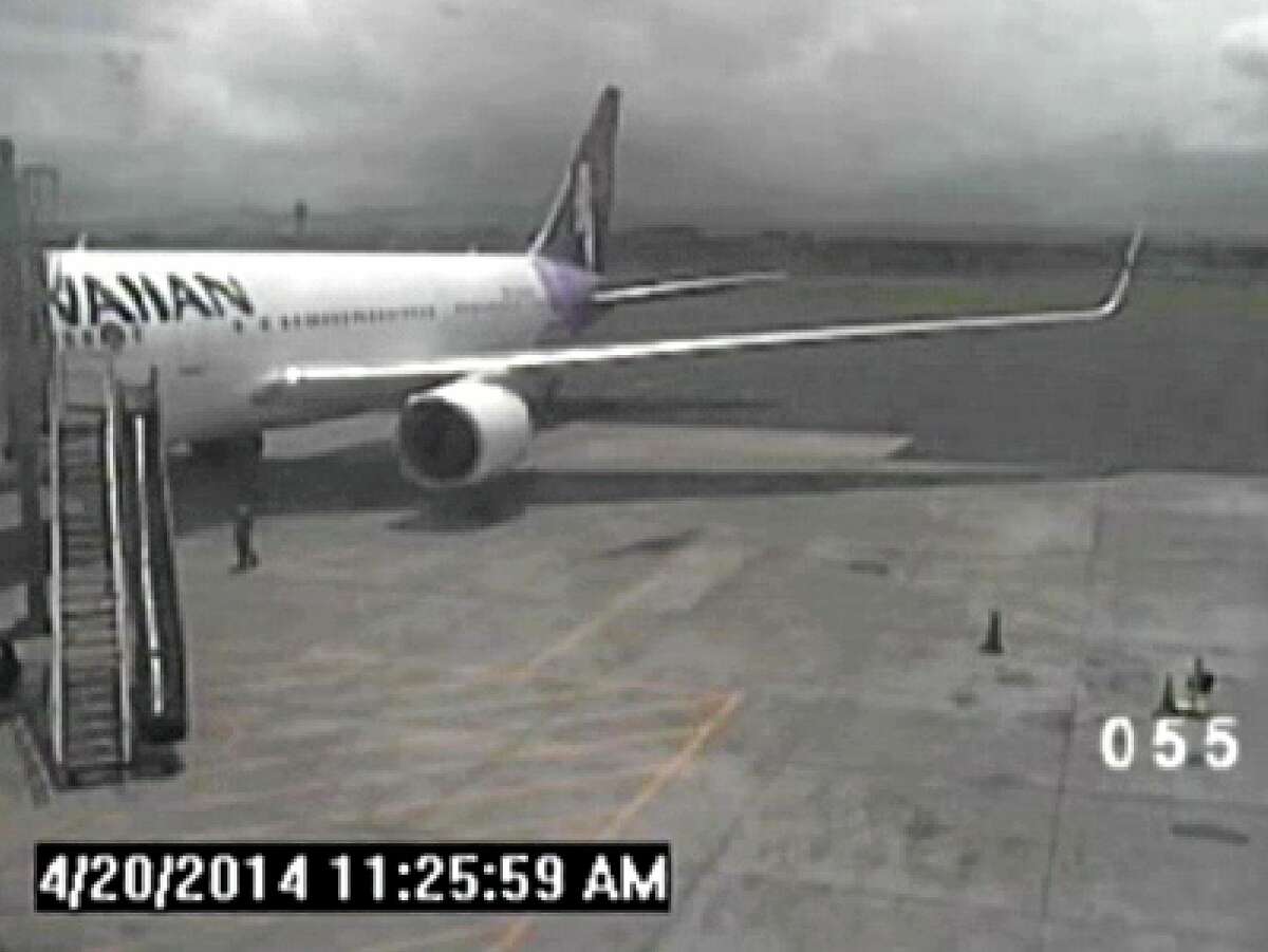 FILE - In this April 20, 2014, file image taken from a surveillance video provided by the Hawaii Department of Transportation, shows a California teen, left, after hopping from a jet's wheel well in Maui, Hawaii. When it was time for that same jet to leave, the pilot, who was a different pilot than the one who had landed the jet there, said security and mechanics were holding him up, according to a ten minute Federal Aviation Administration audio recording, provided exclusively to The Associated Press in response to a Freedom of Information Act request. (AP Photo/Hawaii Department of Transportation, File)