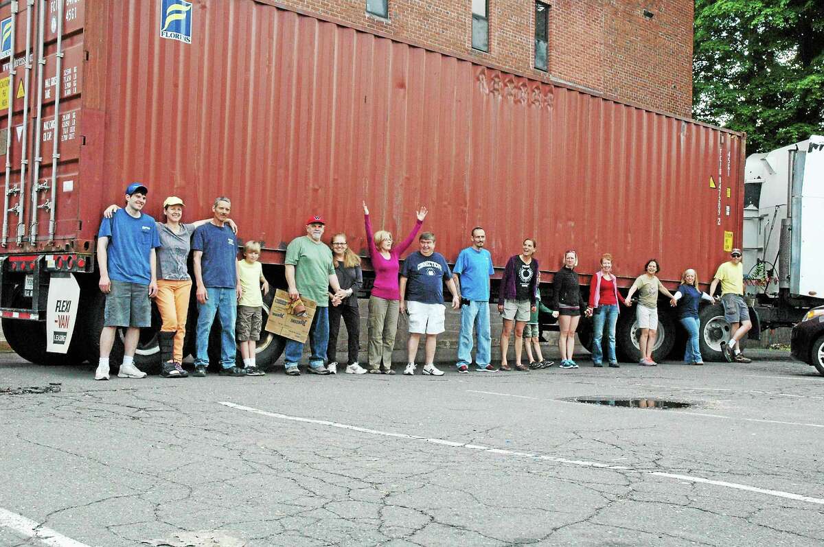 Chris Nolet - Special to the Press Volunteers joined Middletown artist Wendy Black-Nasta, founder of Artists for World Peace, and her husband, musician Robert Nasta to pack a 40-foot container with bicycles and hospital equipment.