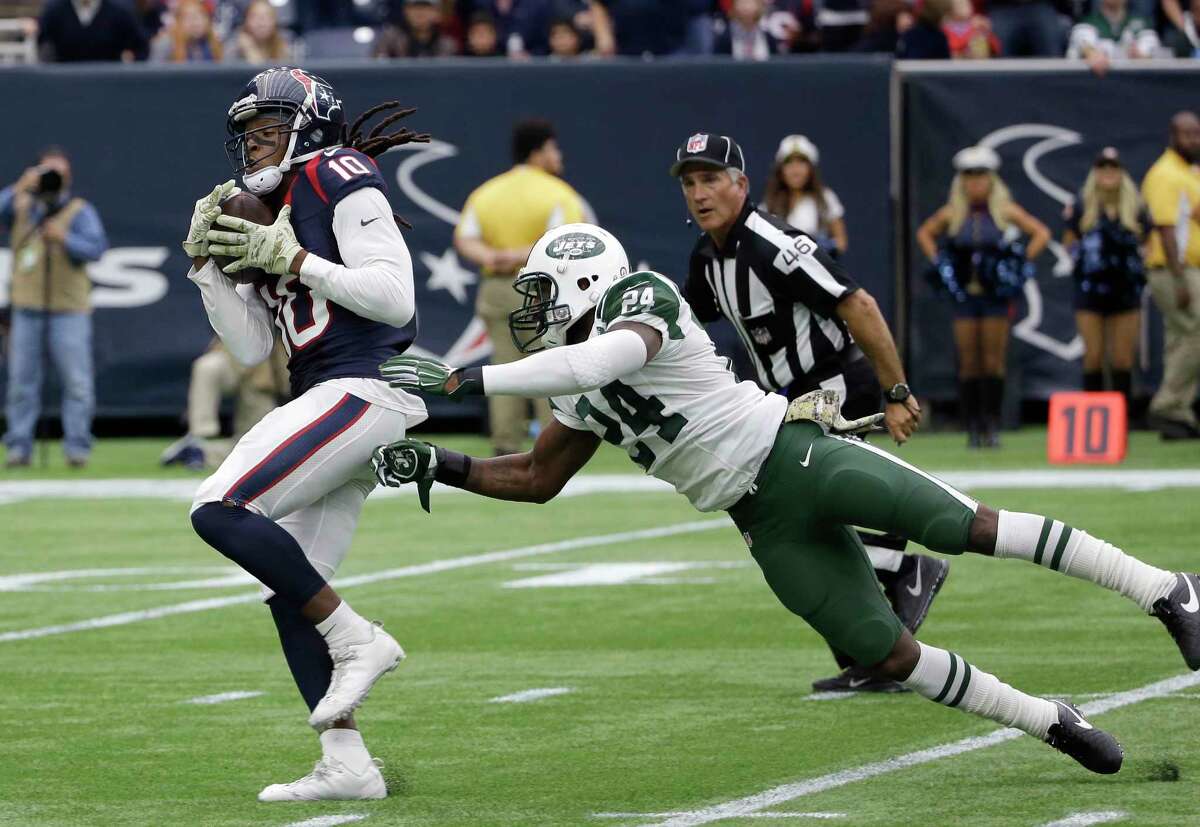 Houston Texans receiver DeAndre Hopkins pulls in a pass for a touchdown by New York Jets cornerback Darrelle Revis on Sunday.