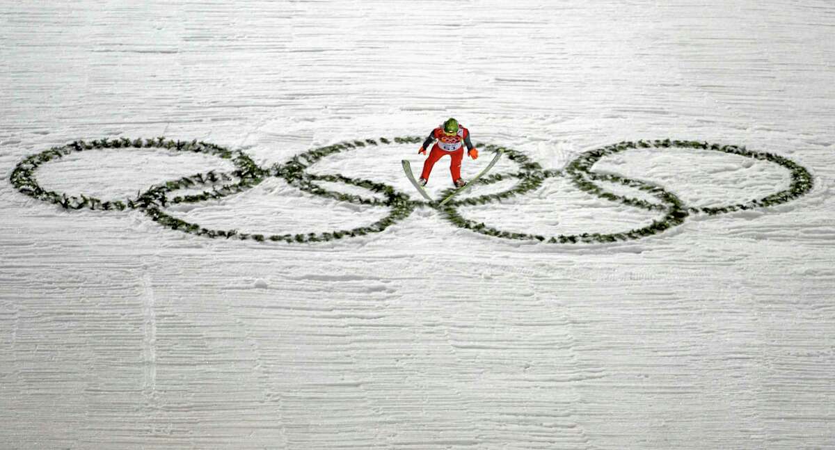 Poland's Kamil Stoch makes his trial jump during the ski jumping large hill qualification at the 2014 Winter Olympics, Friday, Feb. 14, 2014, in Krasnaya Polyana, Russia. (AP Photo/Gregorio Borgia)