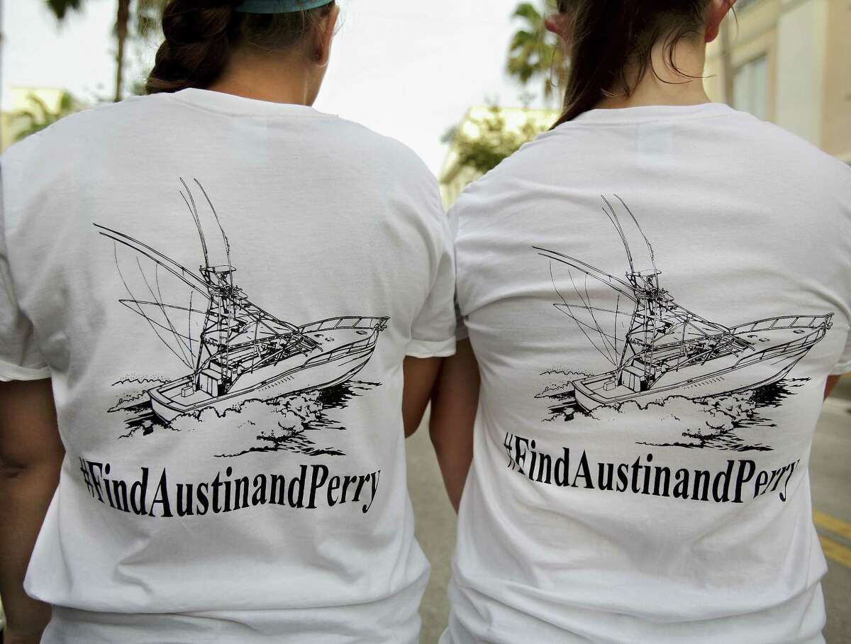 Girls wear T-shirts they bought to help fund the ongoing private search for Nick Cohen and Austin Stephanos who have been missing since they took their boat out of the Jupiter Inlet, Friday, during a fundraiser at Jumby Bay Island Grill, Wednesday in Jupiter, Fla.