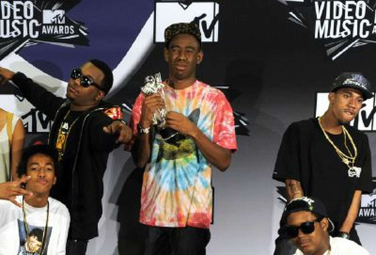 Tyler the Creator, holding the award for best new artist, and Odd Future, pose backstage at the MTV Video Music Awards on Sunday Aug. 28, 2011, in Los Angeles.