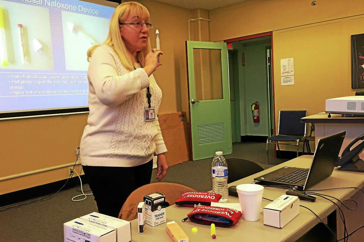 Susan Wolfe, a quality manager with the state Department of Mental Health and Addiction Services, holds a intranasal device used to dispense Narcan during a training session on Tuesday, Nov. 17, in Waterbury. Wolfe has trained more than 1,000 people on how to use the anti-overdose drug since 2012.