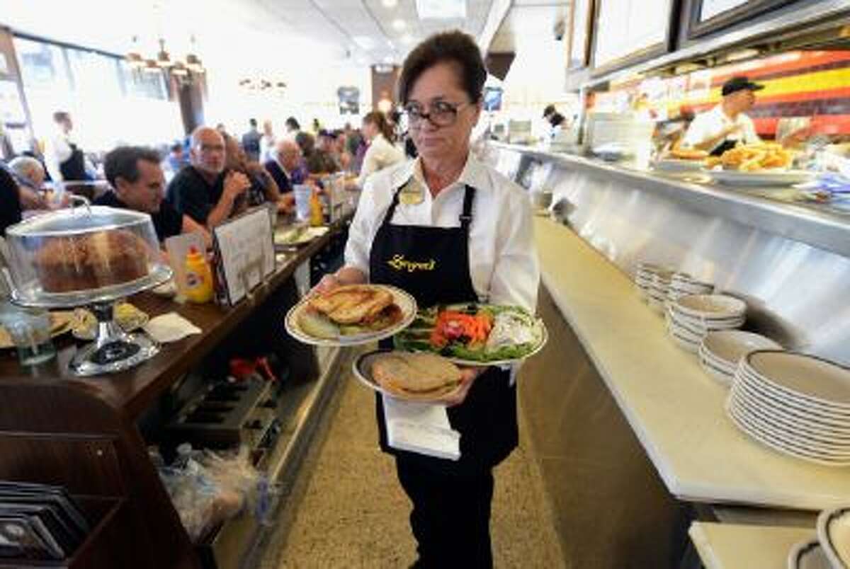 Waitress Sheila Abramson at Langer's Delicatessen serves customers in Los Angeles, Calif. Much of the service industry in America has gone without a raise since 1991.