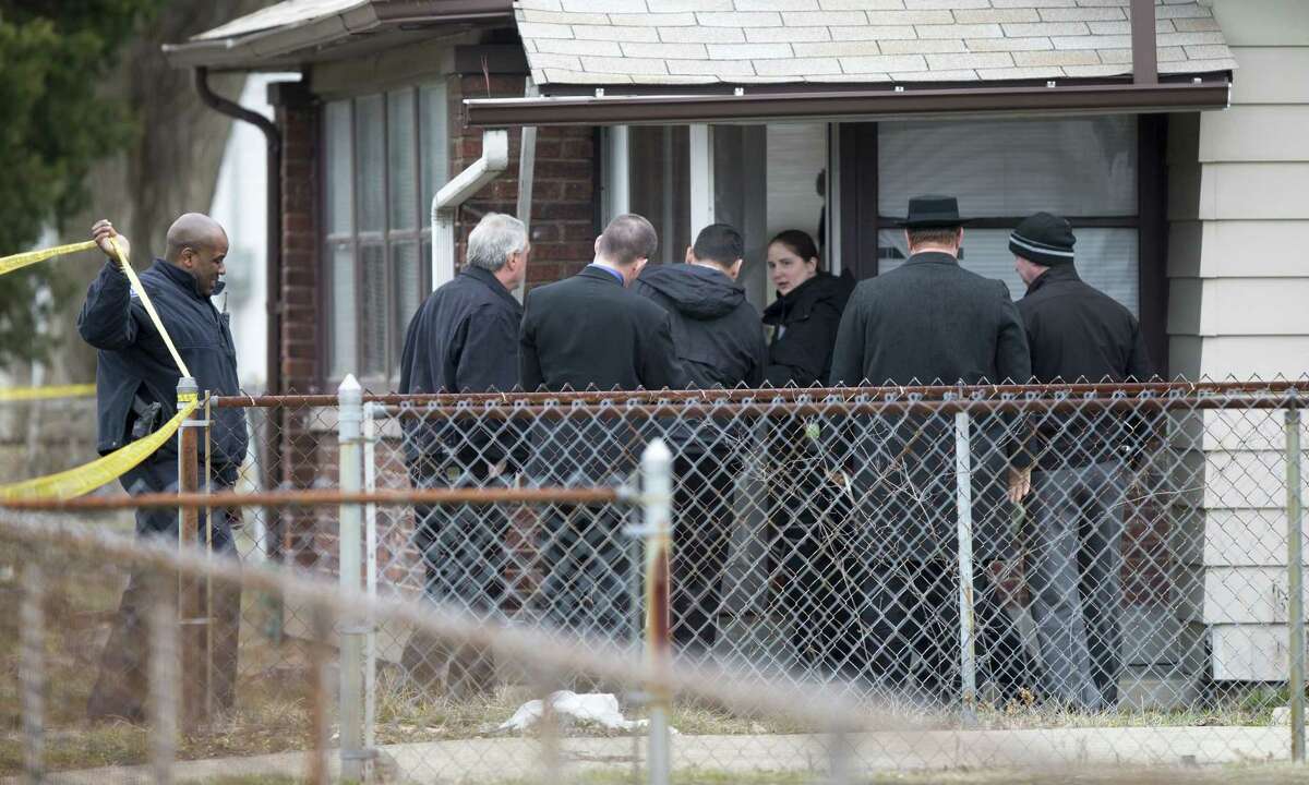 Indianapolis Metropolitan Police Department (IMPD) personnel investigate at 3145 North Harding Street in Indianapolis, at a scene involving four homicide victims, Tuesday, March 24, 2015. Indianapolis Police Chief Rick Hite says three women and a man have been shot to death in the home. Hite says the shootings don't appear random and likely occurred Tuesday morning. (AP Photo/The Indianapolis Star, Robert Scheer) NO SALES