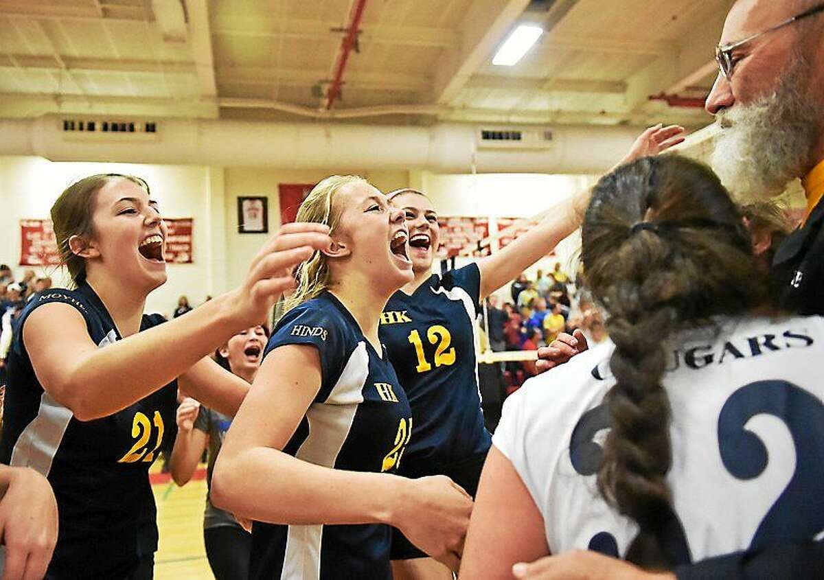 H-K players, from left, Carley Moyher, Mackenzie Hinds, and Lauren Brough celebrate with coach Rich Langer after the Cougars defeated Morgan in the Shoreline Conference championship game at Wilbur Cross High School.