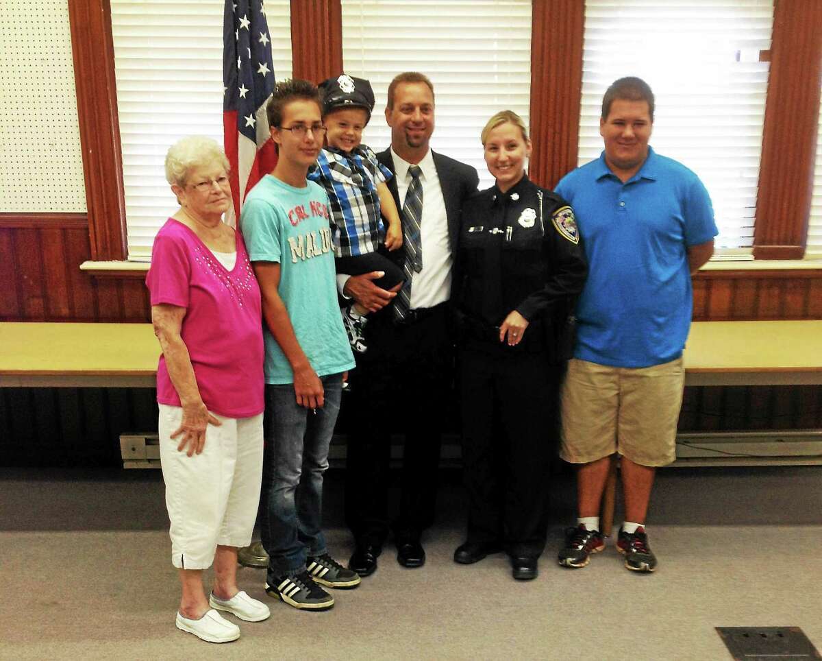 Jeff Mill — The Middletown Press Portland’s newest officer Paul Liseo poses for a photograph with his wife, Middletown officer Brandy Liseo, their three sons, Paul Jr., 16; Alex 14; and Austin, 3; as well as Liseo’s mother.