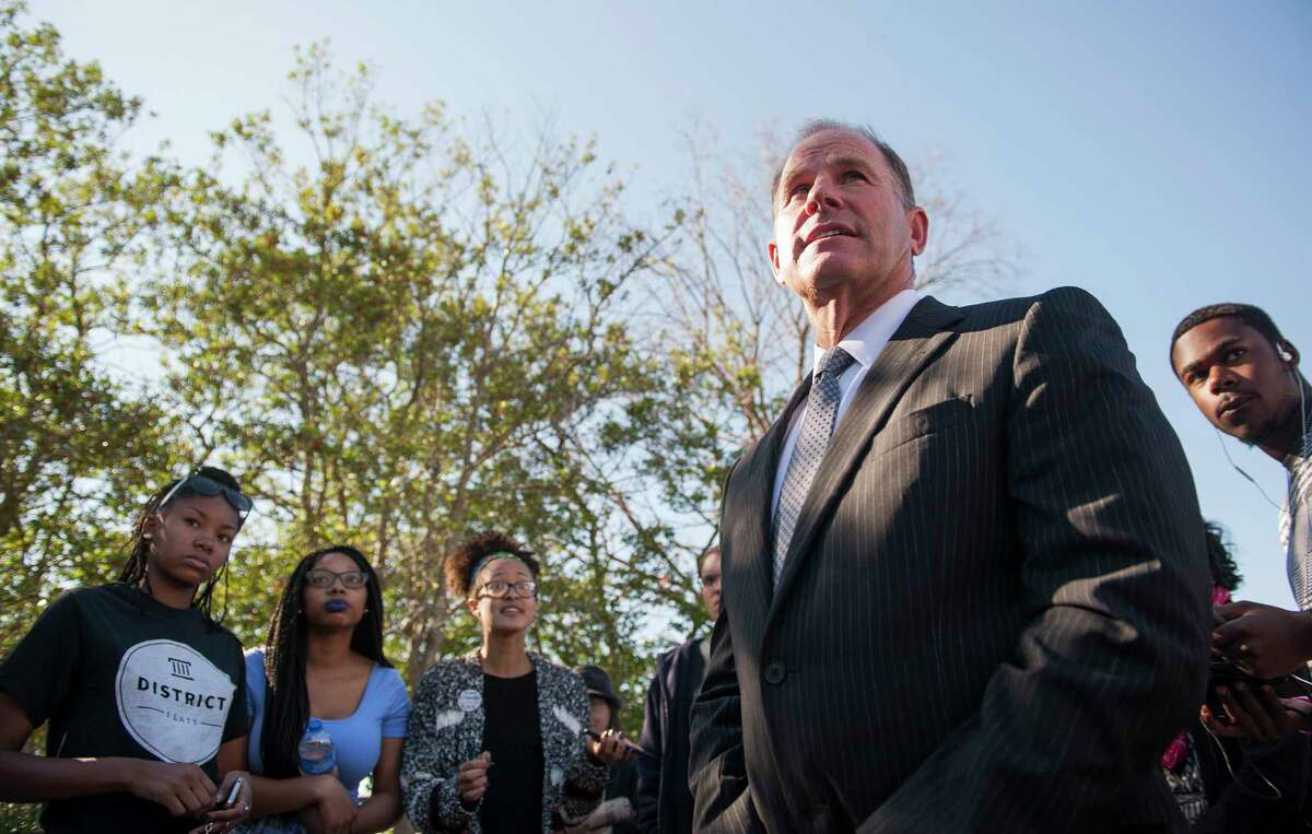 In a Nov. 3, 2015 photo, University of Missouri President Tim Wolfe speaks with members of Concerned Student 1950 senior Abigail Hollis, from left, senior DeShaunya Ware and junior Shelbey Parnell as they call for Wolfe’s resignation outside University Hall on the University of Missouri campus, in Columbia, Mo. Wolfe resigned Monday, Nov. 9, 2015 amid criticism of his handling of racial issues.