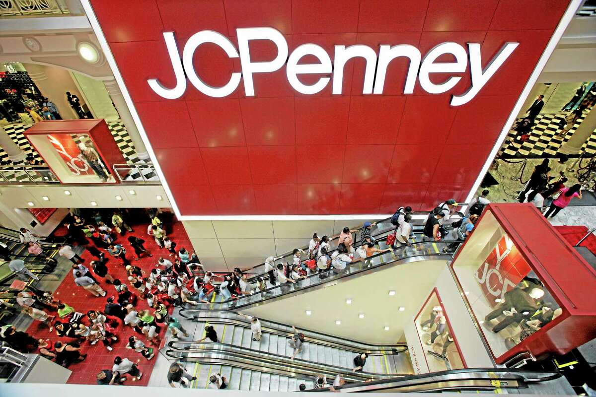 FILE - In this July 31, 2009 file photo, customers are seen in the main entrance of the new JCPenney store in the Manhattan Mall during the grand opening in New York. Tight inventory controls and exclusive store label brands pushed J.C. Penney Co. into profitability in the second quarter, Friday, Aug. 13, 2010. But the department store offered cut its profit outlook because of the uncertain economy. (AP Photo/Mary Altaffer, file)
