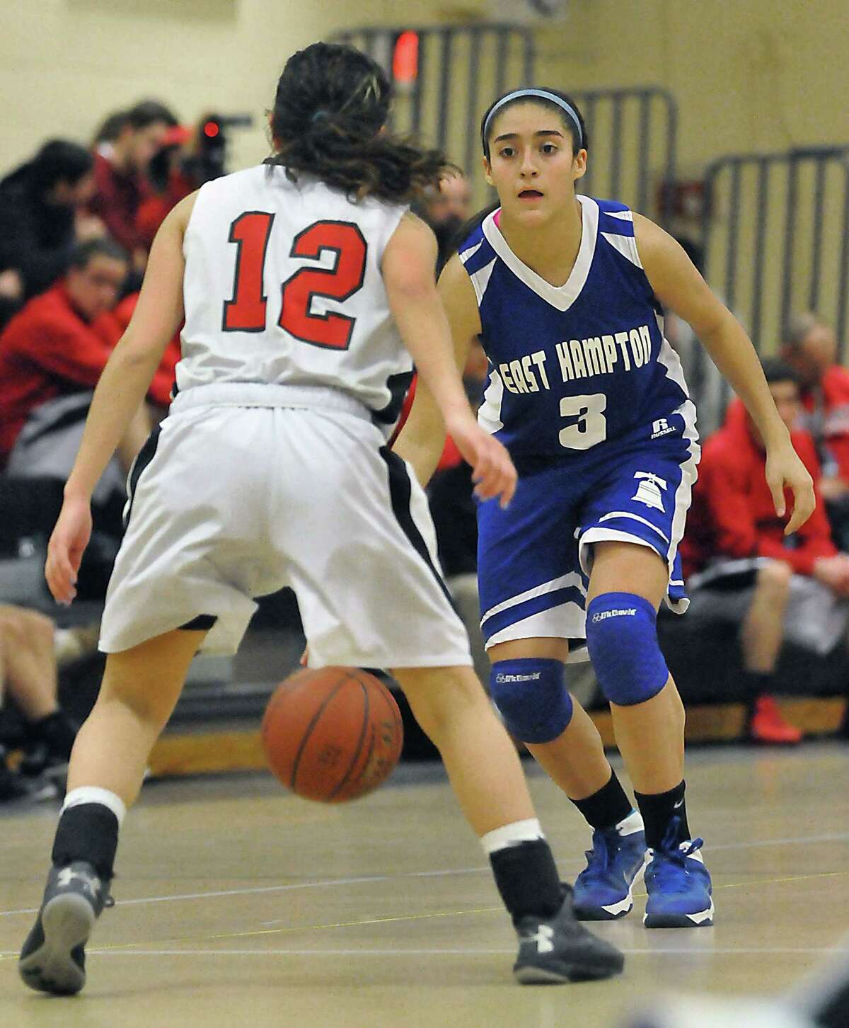 Catherine Avalone - The Middletown Press East Hampton freshman guard Gyanna Russell as Portland's Brittany Cote Tuesday evening in Portland. The East Hampton Bellringers defeated the Portland Panthers 43 - 34.