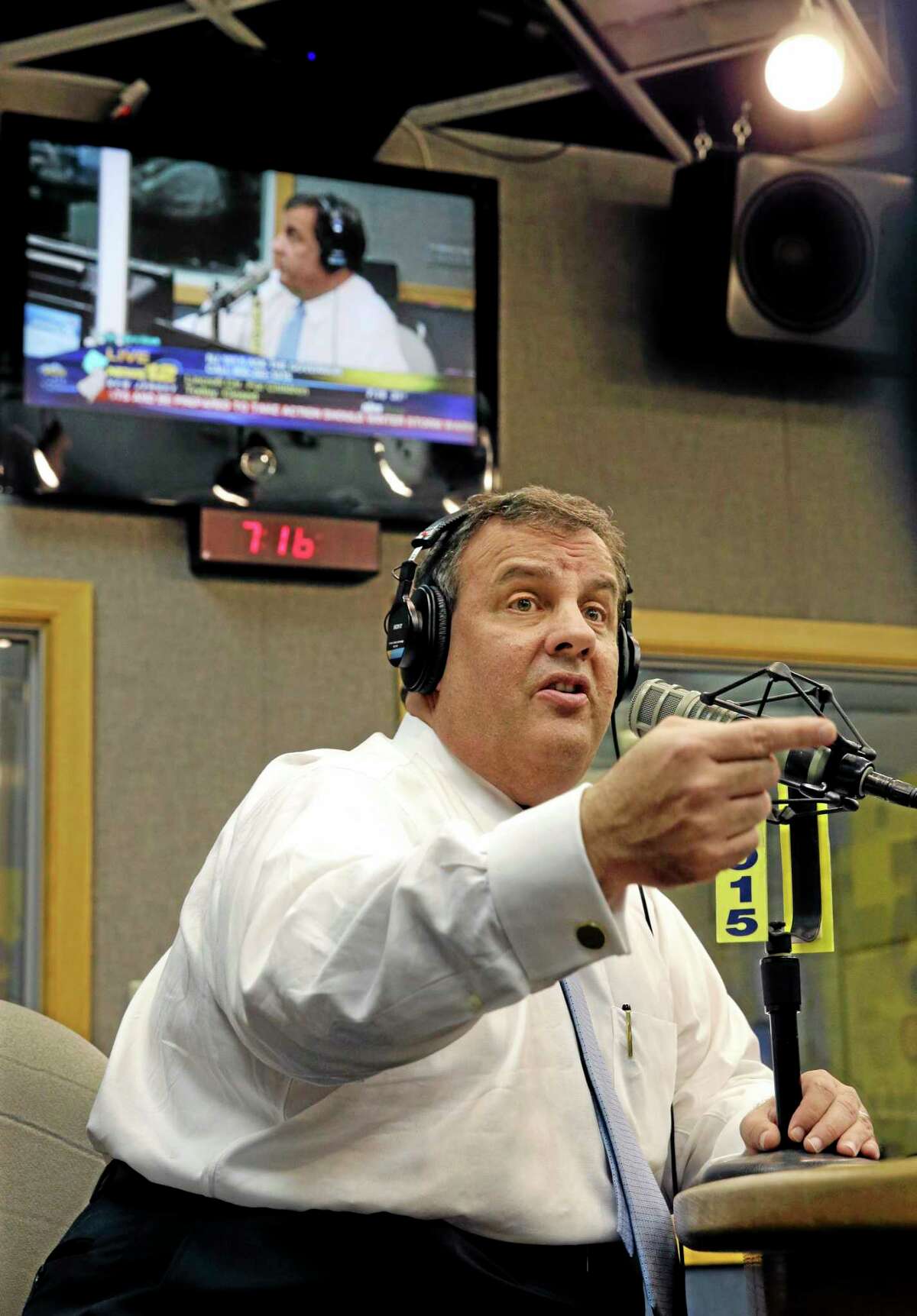 New Jersey Gov. Chris Christie sits in a studio during his radio program, "Ask the Governor" broadcast on NJ 101.5, Monday, Feb. 3, 2014, in Ewing, N.J. During the program, Christie took questions from callers for the first time in more than three weeks as his campaign looked for a way to pay for lawyers as a political payback scandal continues. (AP Photo/Mel Evans, Pool)