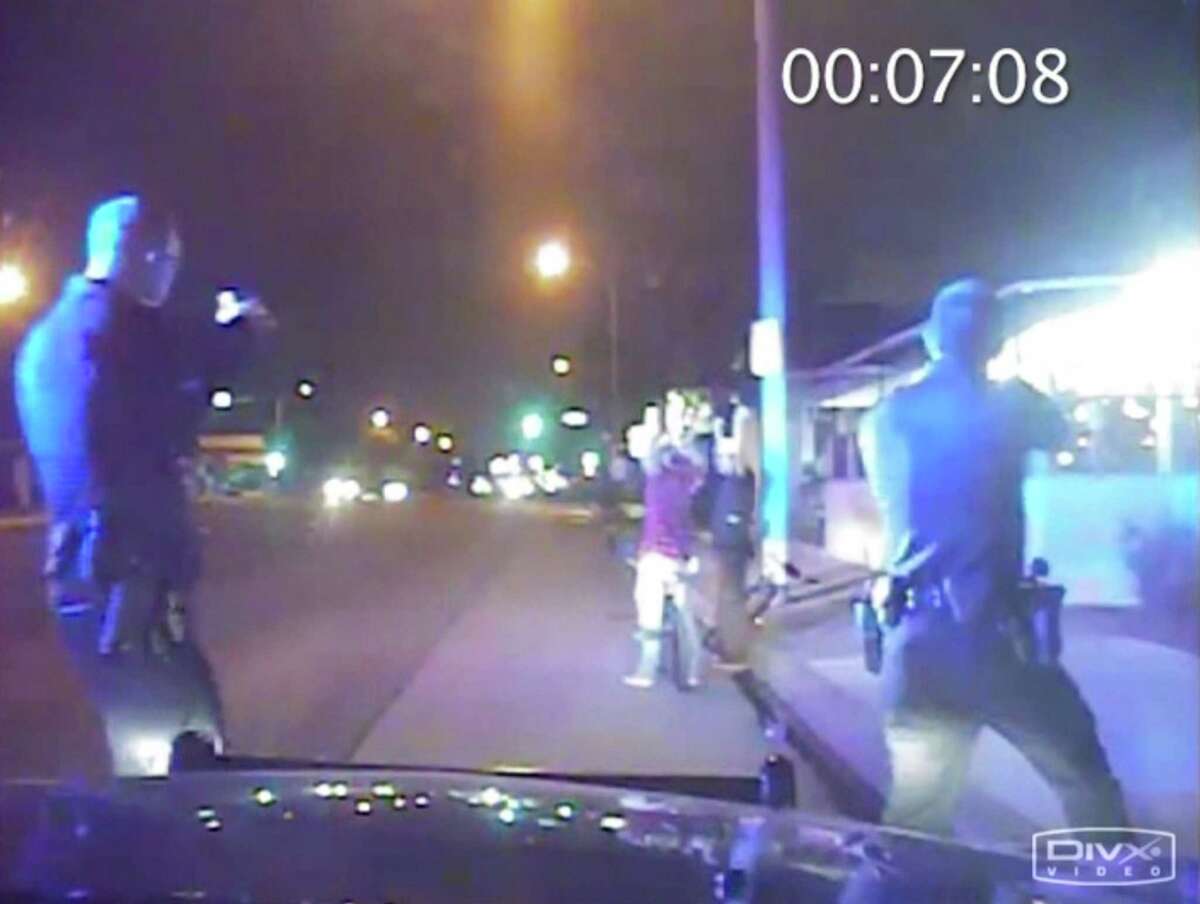 In this June 2, 2013, frame from Gardena Police Department dash-cam video, officers aim their guns at Ricardo Diaz-Zeferino, right, and two friends while investigating a bicycle theft in Gardena, Calif. Moments later police fatally shot Diaz-Zeferino. Hours after a federal judge ordered the release of videos sought by The Associated Press and other news organizations Tuesday, July 14, 2015, a federal appeals court has issued a stay blocking release of the video. (Gardena Police Department)