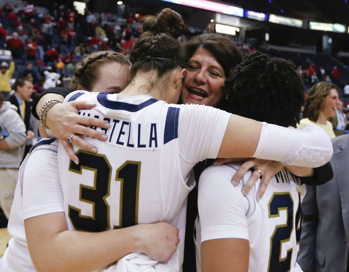 Quinnipiac head coach Tricia Fabbri hugs Gillian Abshire, Sam Guastella and Jasmine Martin after the Bobcats’ 72-61 win over Marist in the MAAC tournament championship game on Monday in Albany, N.Y.