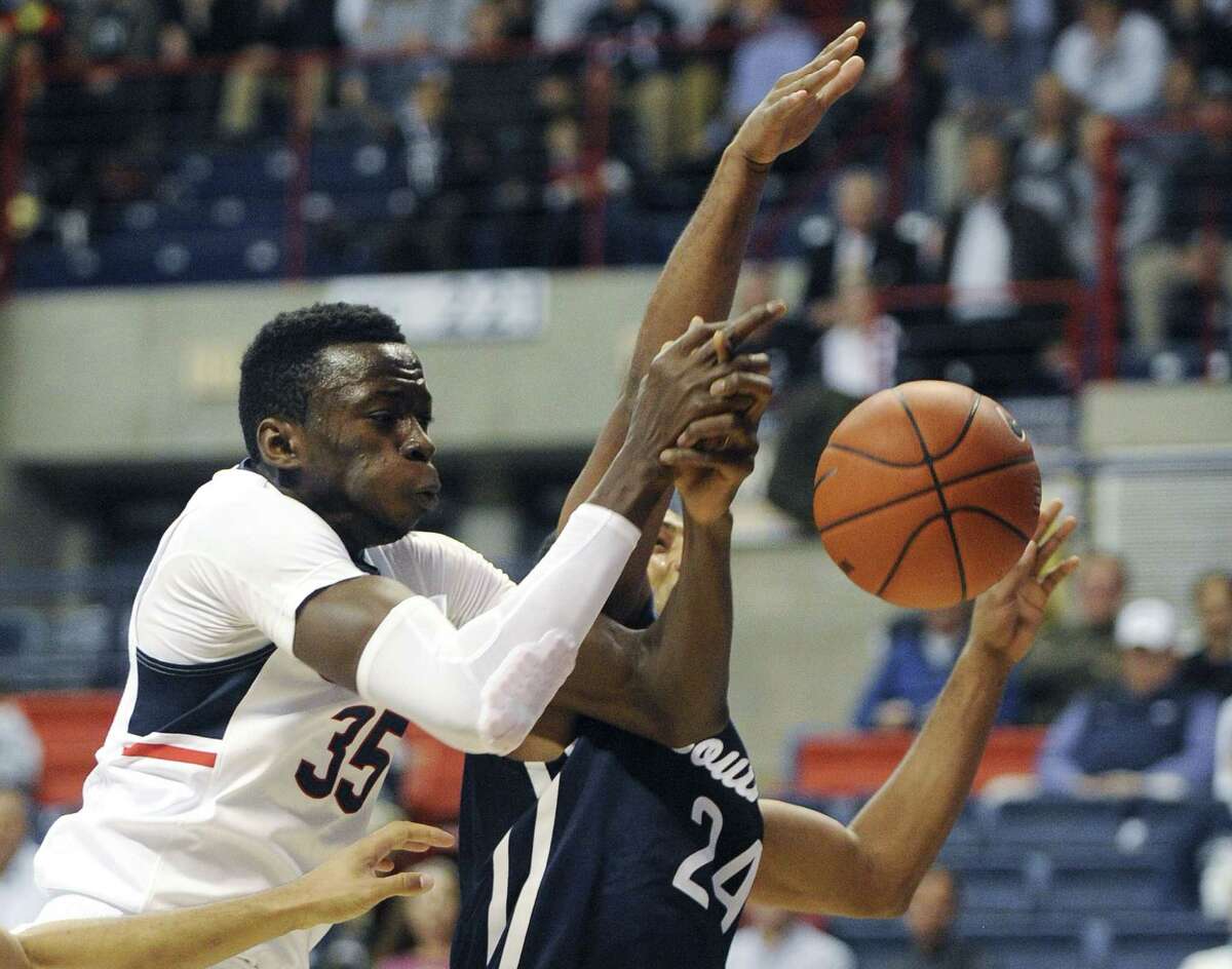 UConn’s Amida Brimah, left, scrambles for a rebound with Southern Connecticut State’s Deshawn Murphy during Tuesday night’s exhibition game in Storrs.