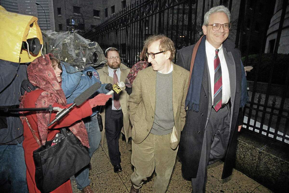 This Jan. 12, 1993 file photo shows director Woody Allen trading grins with a pursuing television reporter as he arrives at State Supreme Court in Manhattan, New York, for a hearing in which he requested more liberal visitation rights with his children during his ongoing dispute with ex-lover actress Mia Farrow. AP Photo/Mario Cabrera