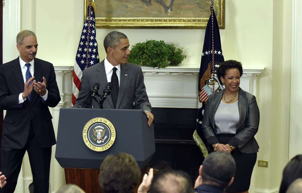 President Barack Obama announces he will nominate U.S. Attorney Loretta Lynch, right, to be the next Attorney General, Saturday, Nov. 8, 2014, in the Roosevelt Room of the White House in Washington. Lynch would succeed Attorney General Eric Holder, left.
