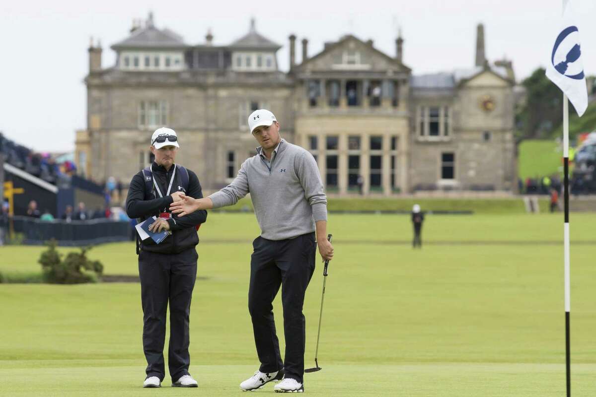 With the clubhouse in the background Jordan Spieth reacts after playing a shot on the first green during a practice round at St Andrews Golf Club on Monday.