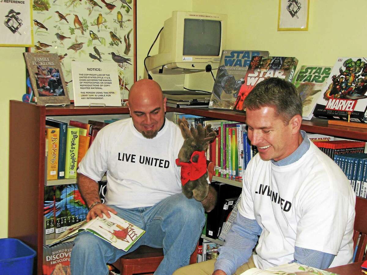 Volunteers from GKN Aerospace Services Structures read with children at the Acton Public Library in Old Saybrook as part of Middlesex United Way’s annual Day of Caring. More than 40 volunteers from nine companies participated in Day of Caring projects in seven Middlesex County towns during October and November.