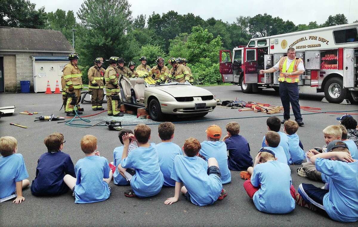 Cromwell Fire Chief Stephen Pendl explains to Cub Scouts from six troops including Pack 9 of Cromwell what happens after a car accident Tuesday morning at Pierson Park.