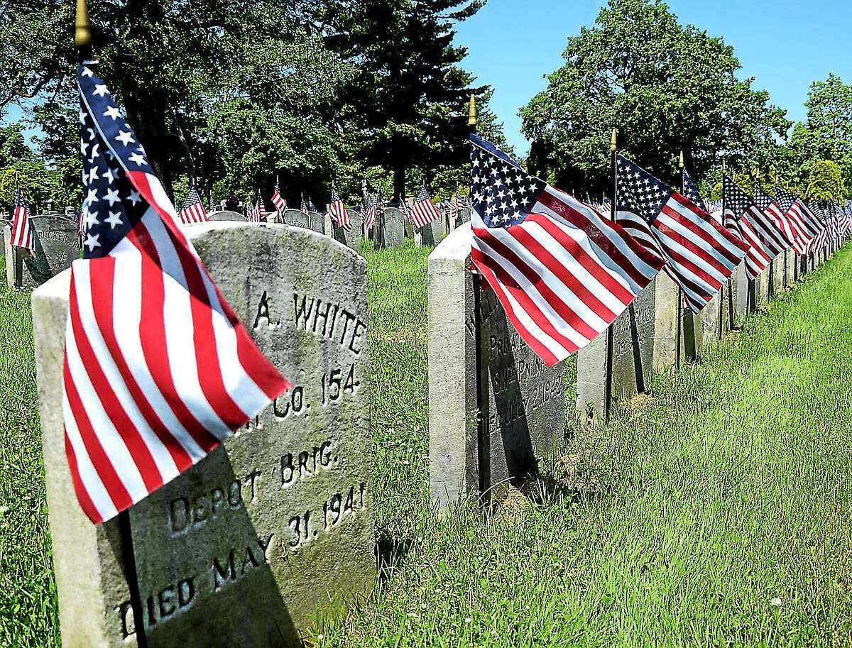 Veterans graves are decorated with flags to mark Memorial Day in the Field of Honor in Greenwood Cemetary in Hamilton. gregg slaboda photo