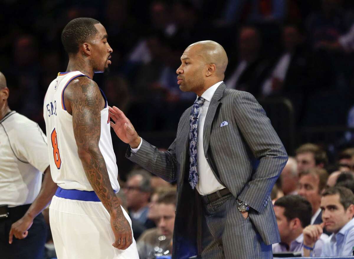 Knicks head coach Derek Fisher talks to J.R. Smith during an Oct. 29 game against the Chicago Bulls in New York.