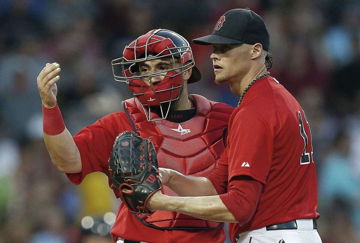Red Sox catcher Sandy Leon, left, signals to the dugout beside Clay Buchholz during the fourth inning Friday against the New York Yankees in Boston.