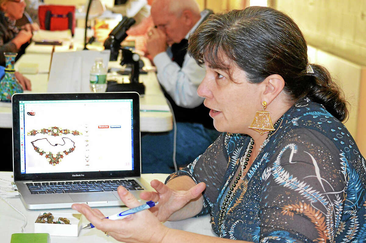 Contributed photo Gaye Sherman Weintz of Ivoryton is a highly knowledgeable appraiser of vintage and antique costume jewelry and well versed in the history of all the old companies and designers. She and Paul Indorf, owner of CT Jewelry Appraisers (shown in background) often work together to share their expertise.