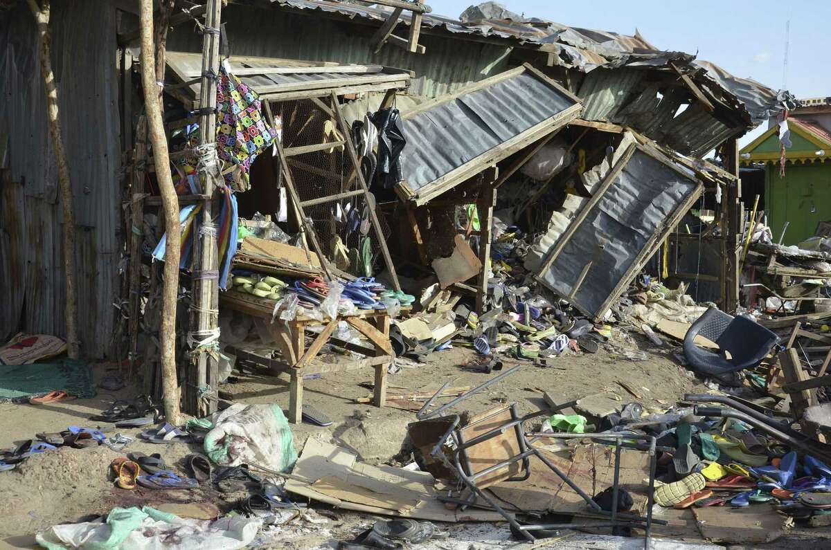 Debris at the site of a suicide bomb attack at a market in Maiduguri, Nigeria, Monday June 22, 2015. Two girls blew themselves up on Monday near a crowded mosque in northeast Nigeria's biggest city, killing about 30 people, witnesses said. It is the fourth suicide bombing this month in Maiduguri, which is the birthplace of the Boko Haram Islamic extremist group. (AP Photo/Jossy Ola)