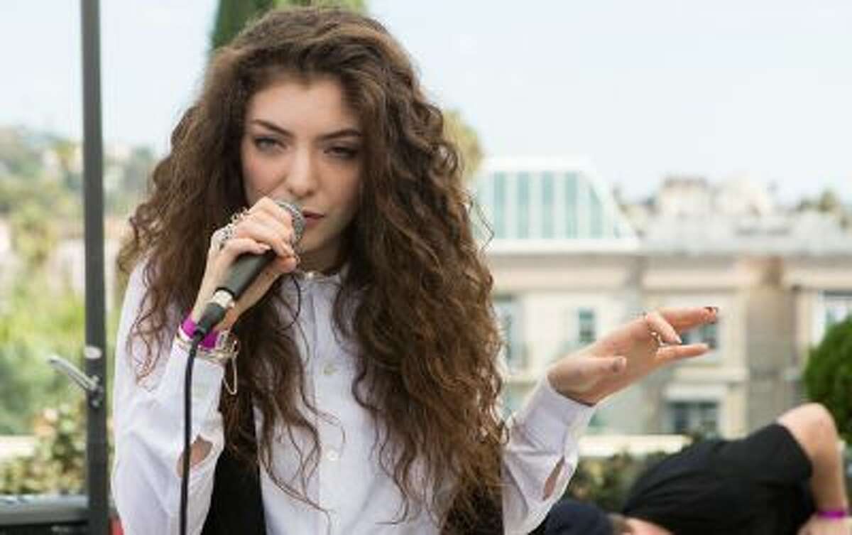 FILE - This Sept. 25, 2013 file photo shows recording artist Lorde performing an at the Alt 98.7 Penthouse inside the Hollywood Tower in Los Angeles. The Lumineers, Lorde and Ed Sheeran will perform at a concert Nov. 11 to celebrate Vh1ís ìYou Oughta Knowî campaign. (Photo by Paul Hebert/Invision/AP, File)