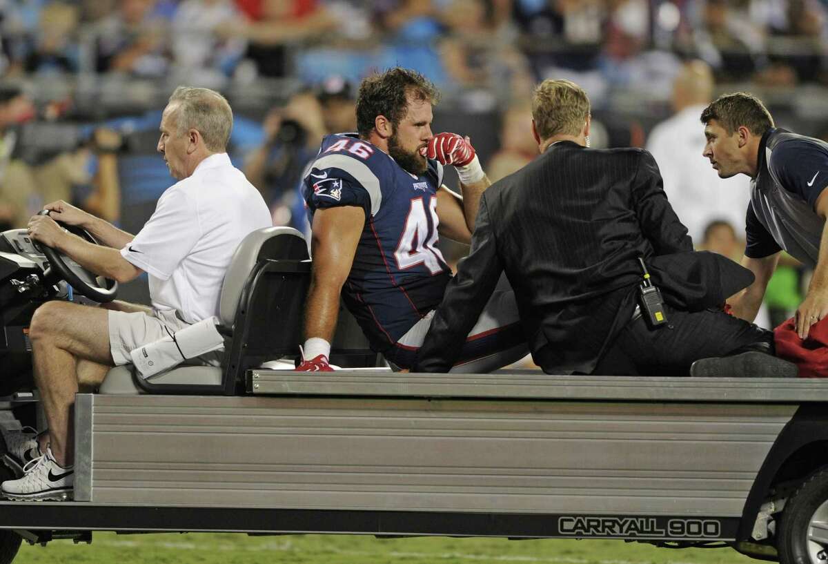 Patriots fullback James Develin (46) is helped off the field on a cart after being injured in Friday’s preseason game against the Panthers.
