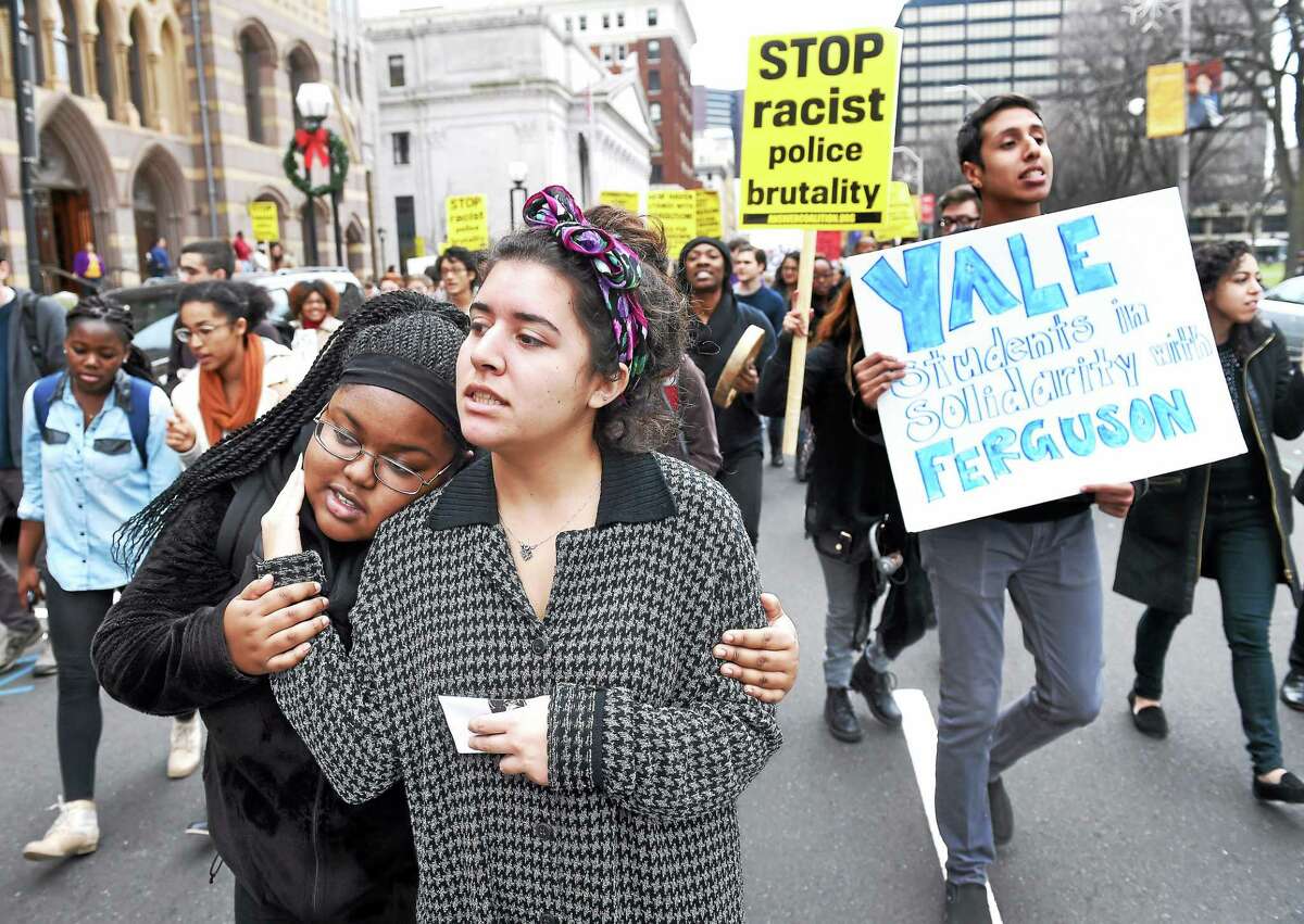 Yale University students Carlene Ervin (left) and Cathleen Calderon walk back to campus after a march to New Haven City Hall during the Ferguson protest, Hands Up Walk Out, organized by the Black Student Alliance at Yale on Dec. 1, 2014.